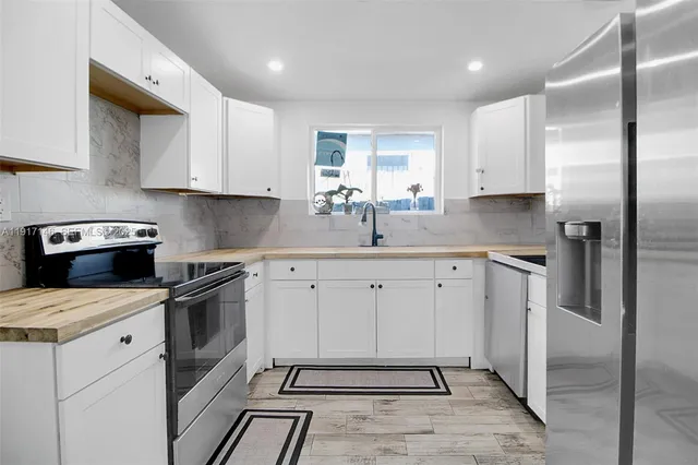 a kitchen with a sink stove and refrigerator