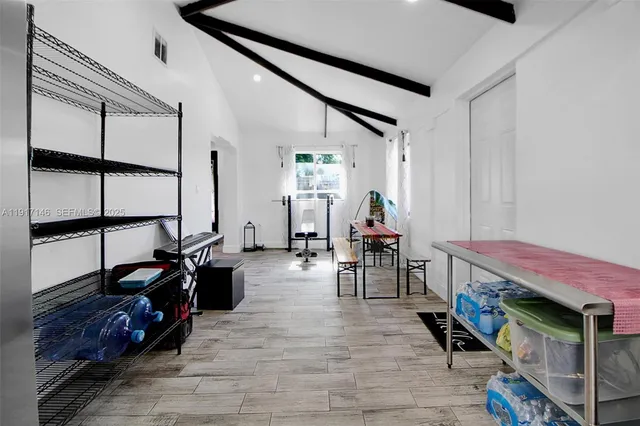 a living room with furniture a wooden floor and a window