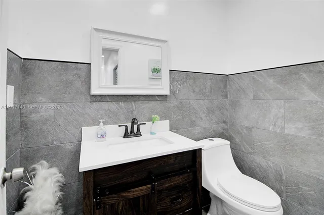 a bathroom with a sink toilet and mirror