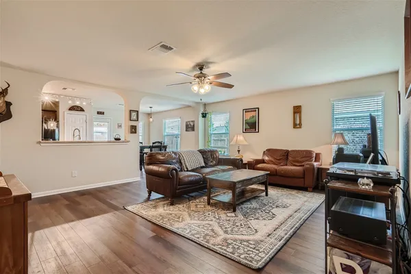 a living room with furniture and wooden floor