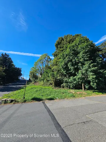 a view of a road with a building in the background