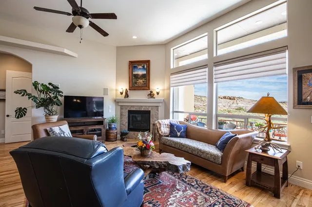 a living room with furniture a fireplace and a flat screen tv