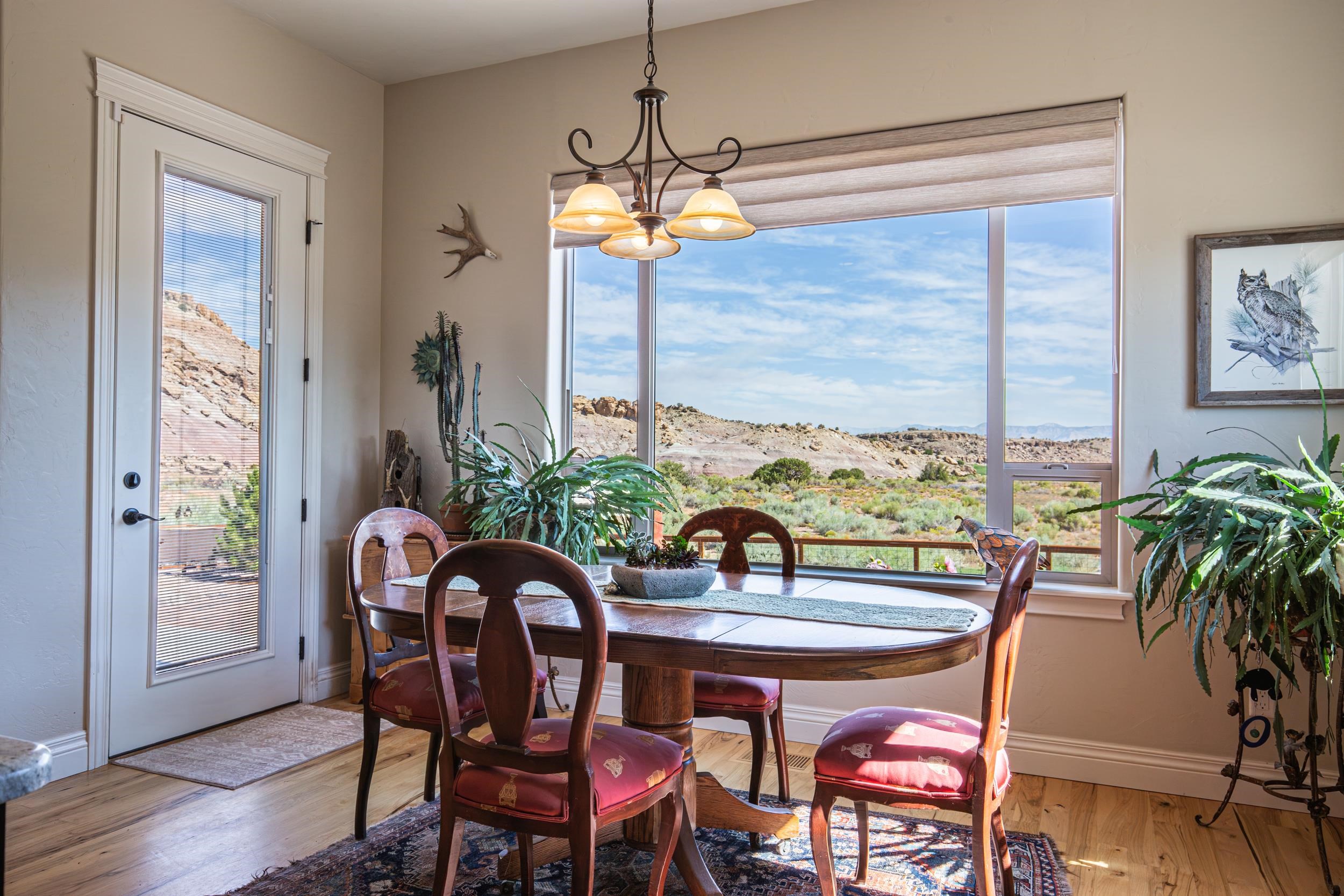 326 Red Point Road Grand Junction, CO 81507 - Photo 14 of 37 a dining room with furniture a chandelier and wooden floor