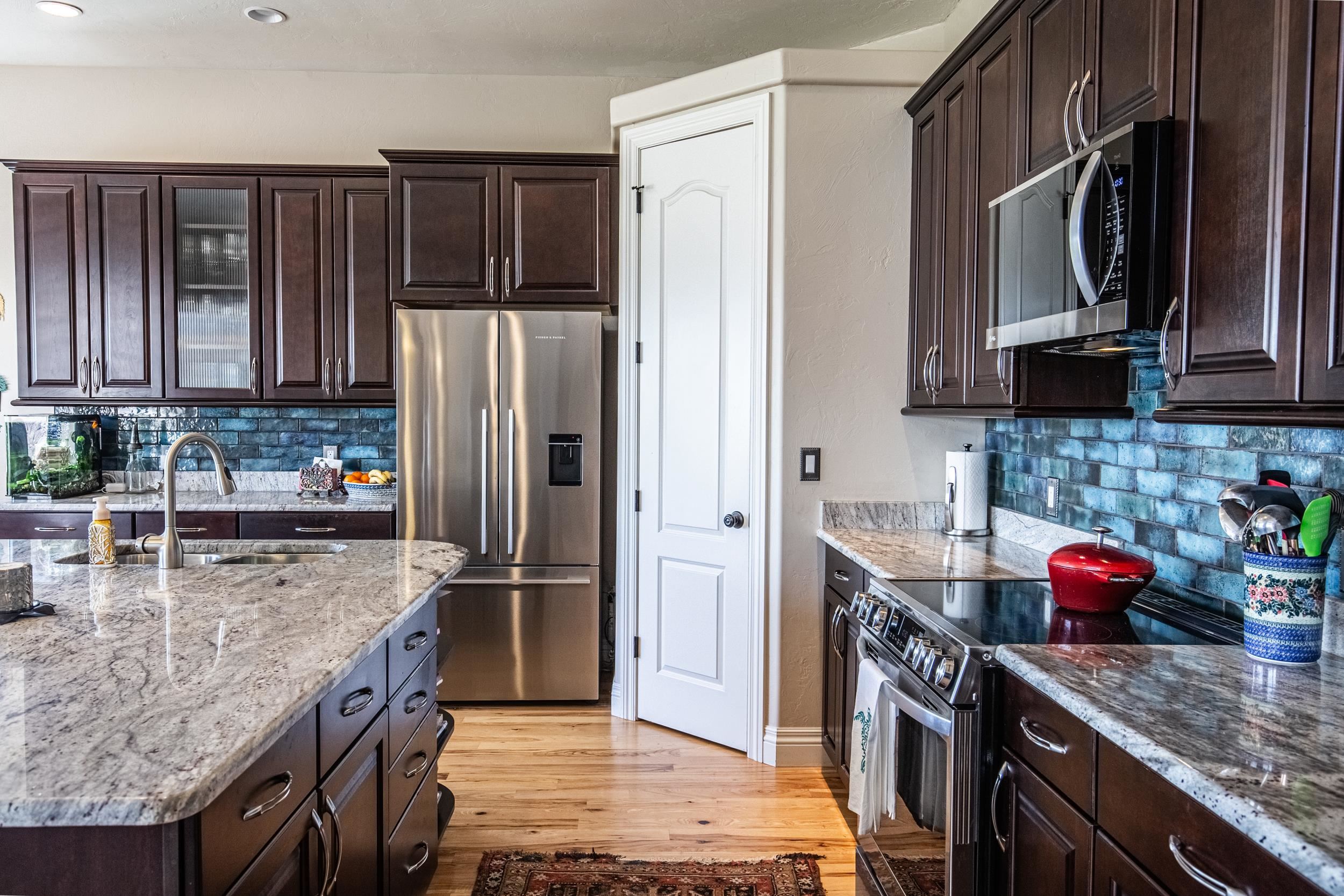 326 Red Point Road Grand Junction, CO 81507 - Photo 16 of 37 a kitchen with granite countertop a refrigerator stove and microwave