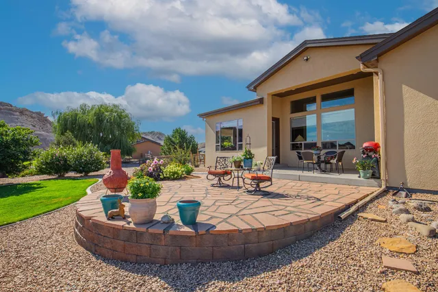 a view of a house with backyard sitting area and garden