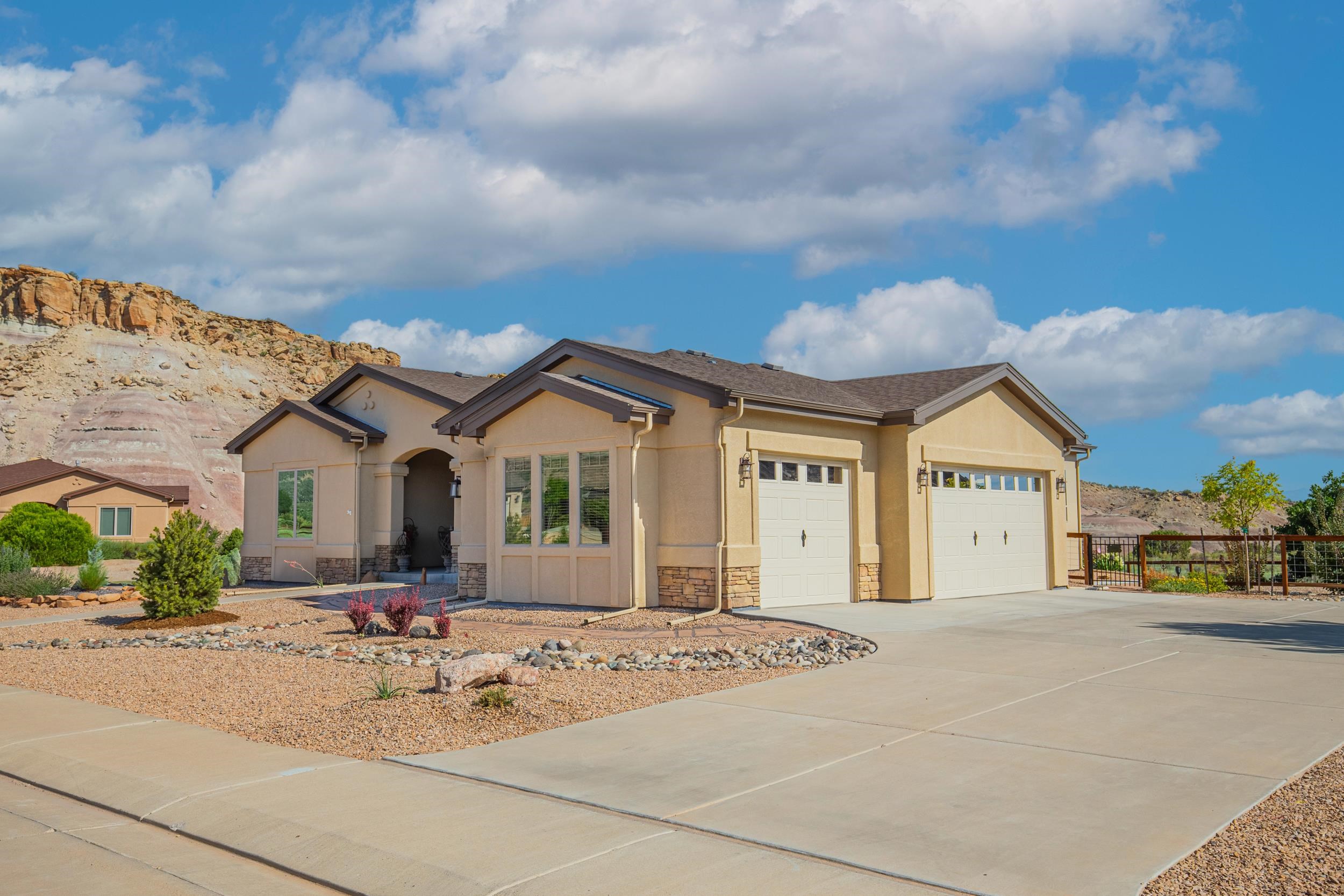 326 Red Point Road Grand Junction, CO 81507 - Photo 3 of 37 a view of a white house with a large windows and a yard
