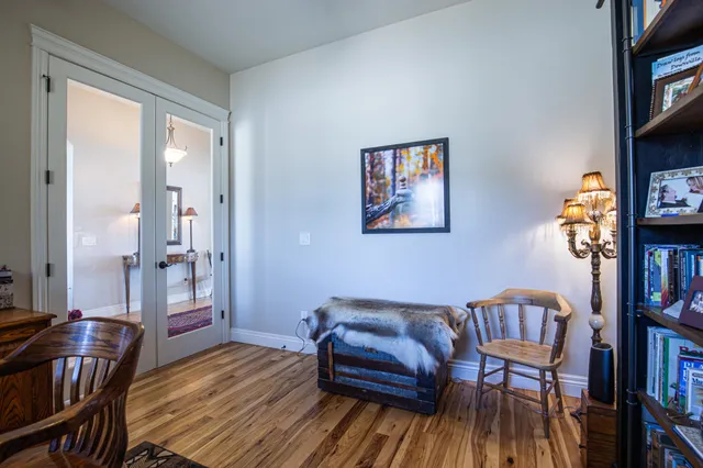 a living room with furniture and a book shelf