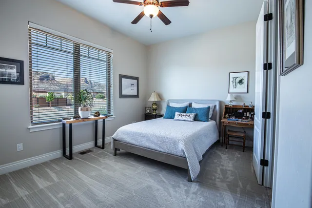 a bedroom with a bed and a chandelier