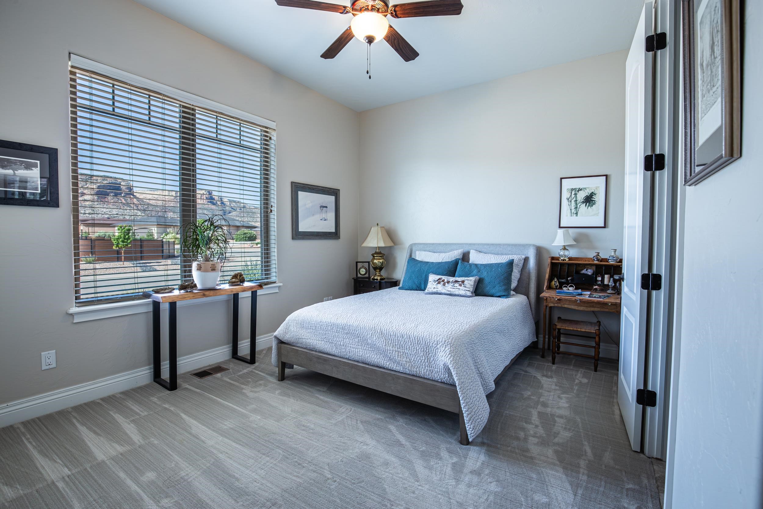 326 Red Point Road Grand Junction, CO 81507 - Photo 8 of 37 a bedroom with a bed and a chandelier