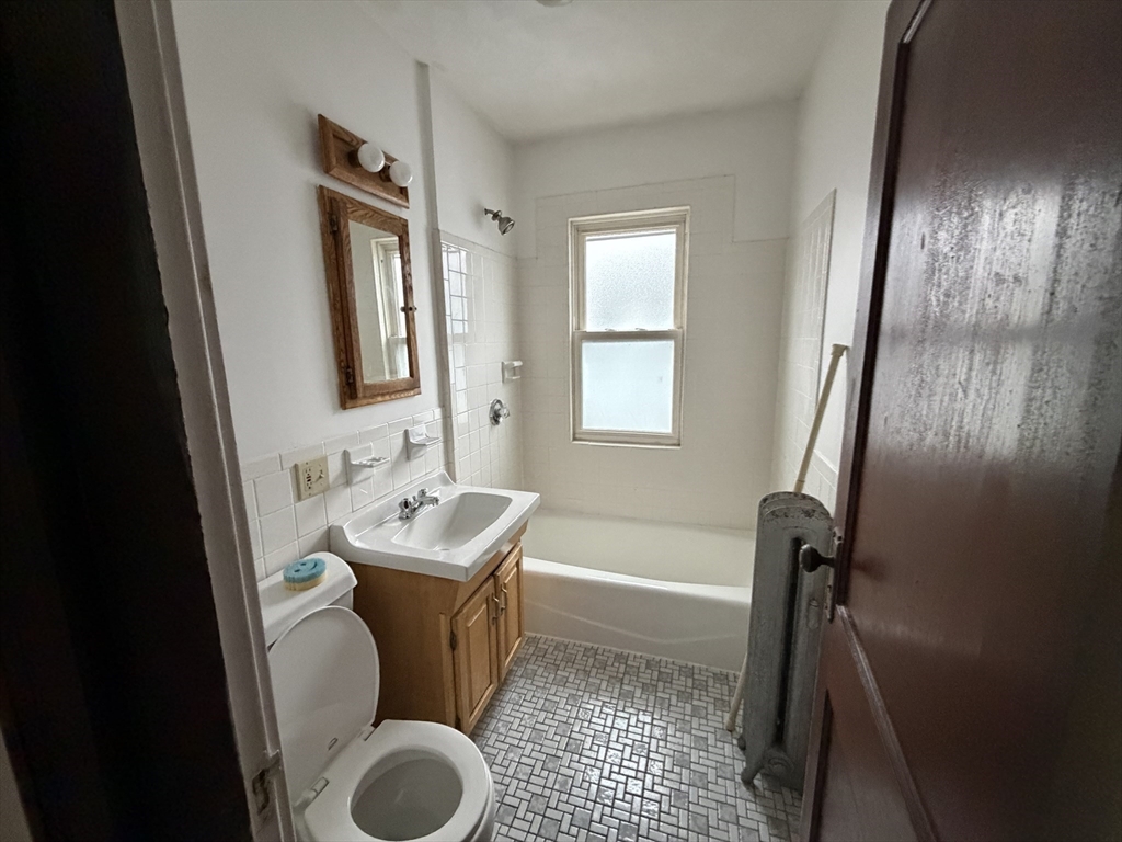 44 Varnum Street, Unit 2 Arlington, MA 02474 - Photo 17 of 19 a bathroom with a sink toilet and shower