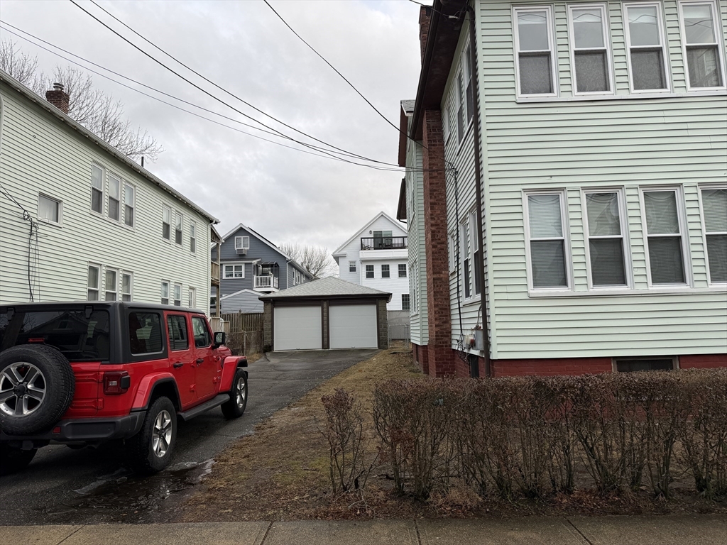 44 Varnum Street, Unit 2 Arlington, MA 02474 - Photo 2 of 19 a front view of a house with a parking space