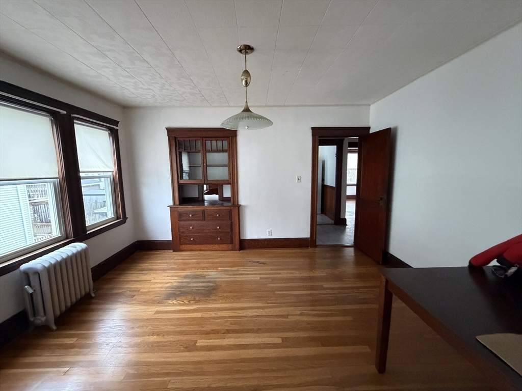 44 Varnum Street, Unit 2 Arlington, MA 02474 - Photo 5 of 19 a view of a livingroom with wooden floor and furniture