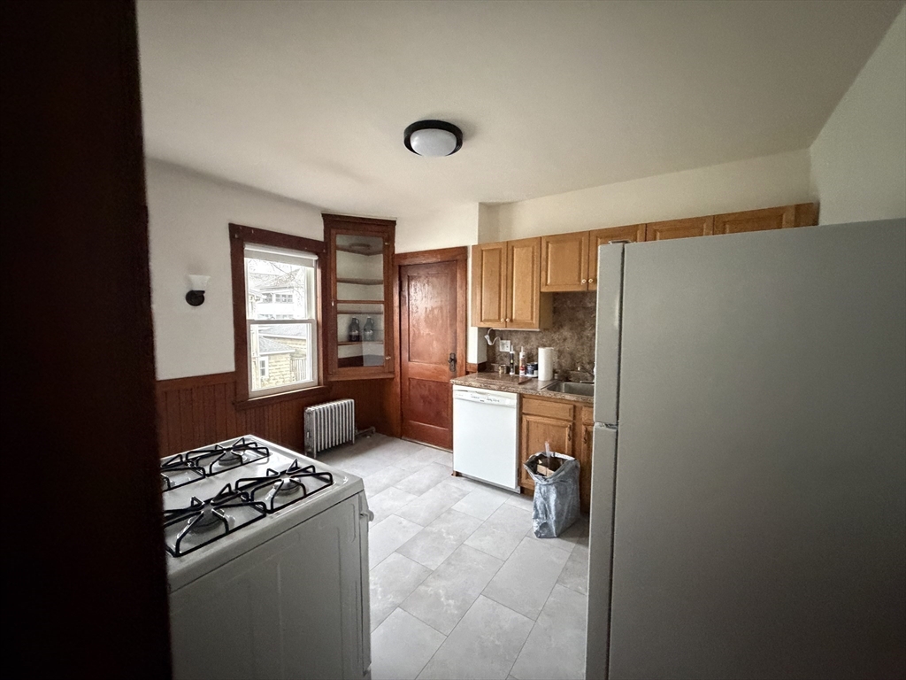 44 Varnum Street, Unit 2 Arlington, MA 02474 - Photo 8 of 19 a kitchen with refrigerator and window
