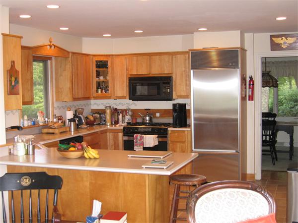 5 Dogwood Road, Unit H5 Bourne, MA 02532 - Photo 3 of 10 a kitchen with stainless steel appliances granite countertop a refrigerator a stove and a sink with wooden floor