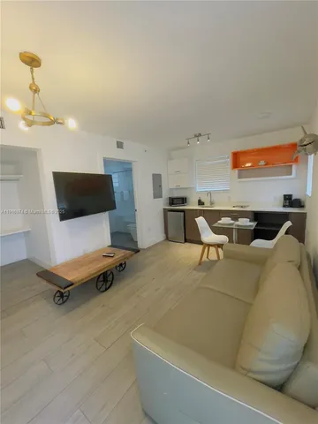 a living room with furniture pool table and projector screen