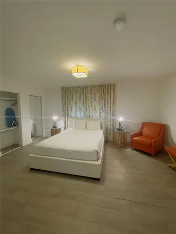 a bedroom with a bed and lamp
