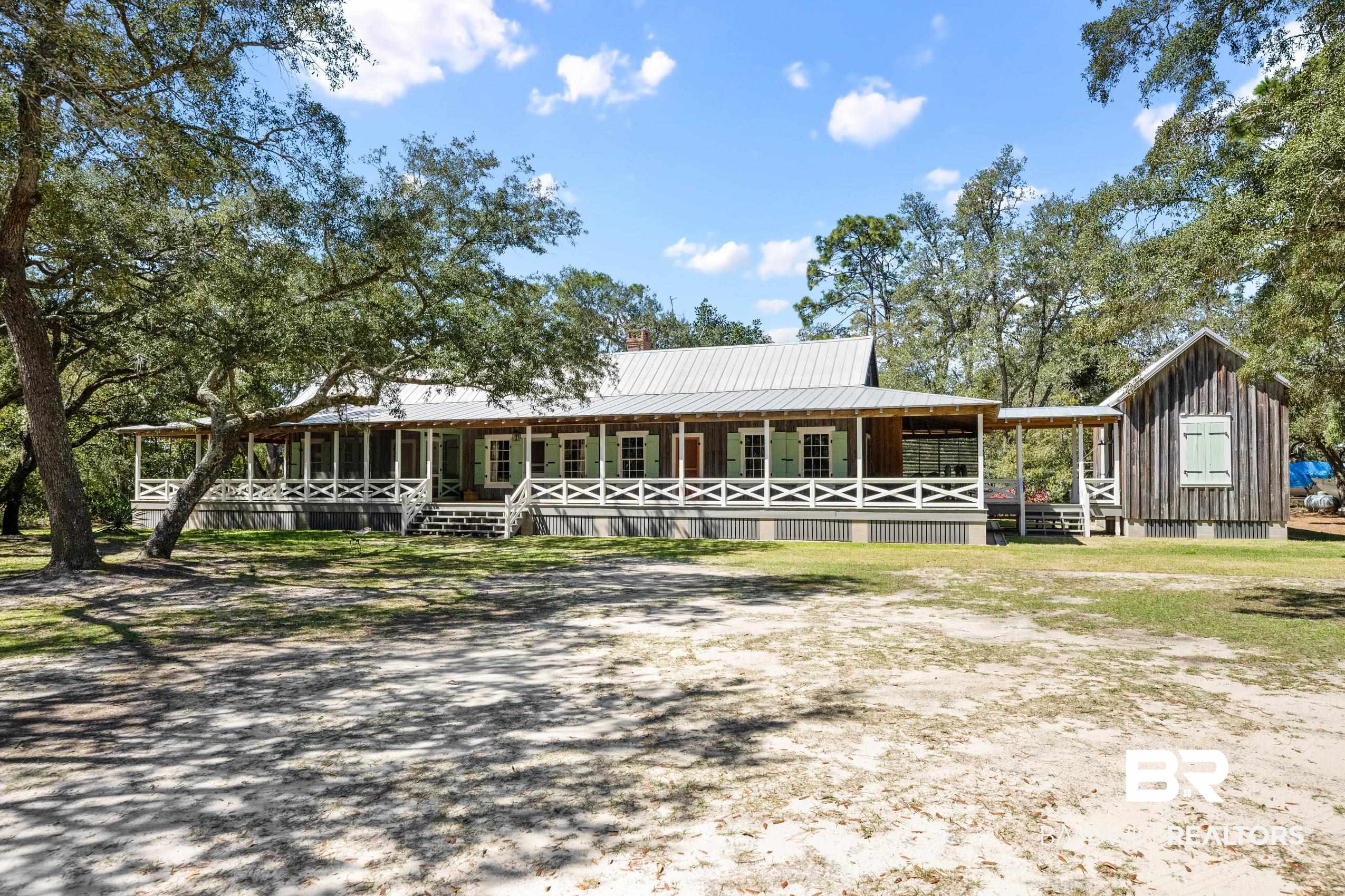 30671 Magnolia Street Elberta, AL 36530 - Photo 14 of 68 View of front facade with covered porch, metal roof, and board and batten siding