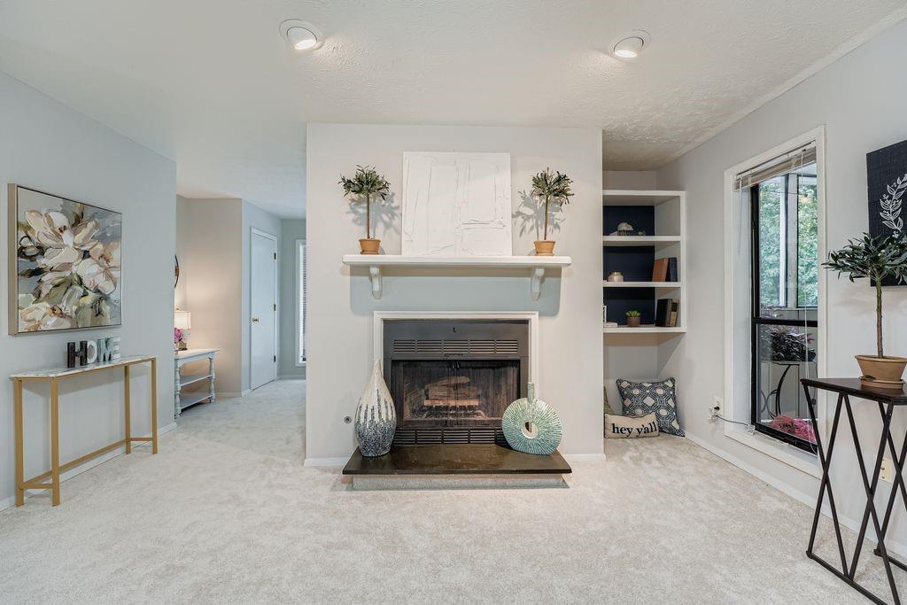 a living room with furniture and a fireplace