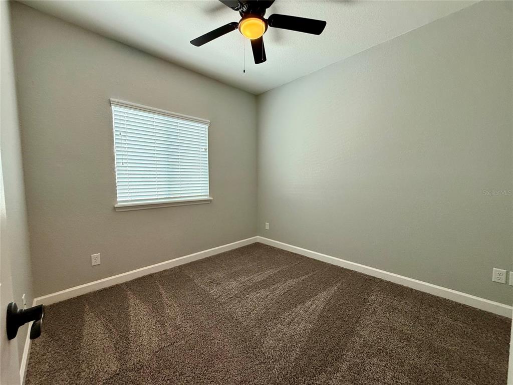 2783 Sycamore Street Winter Haven, FL 33881 - Photo 11 of 32 an empty room with window and a ceiling fan