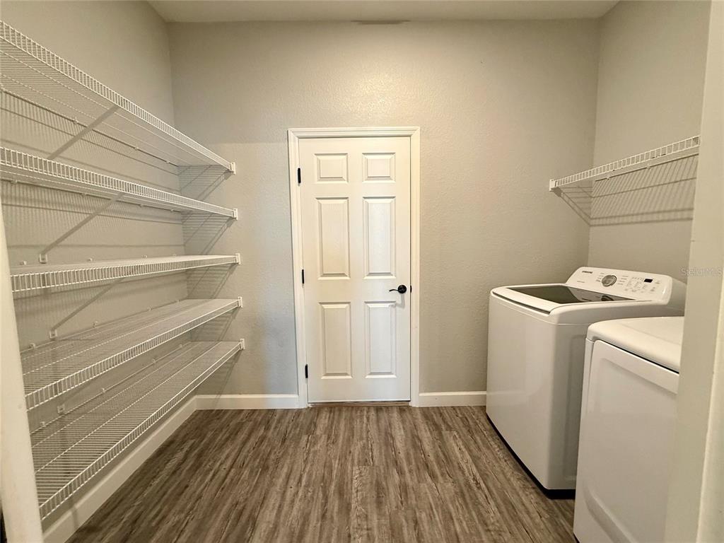 2783 Sycamore Street Winter Haven, FL 33881 - Photo 16 of 32 a view of storage and utility room with washer and dryer