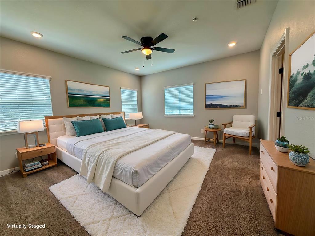2783 Sycamore Street Winter Haven, FL 33881 - Photo 6 of 32 a spacious bedroom with a large bed and a chandelier
