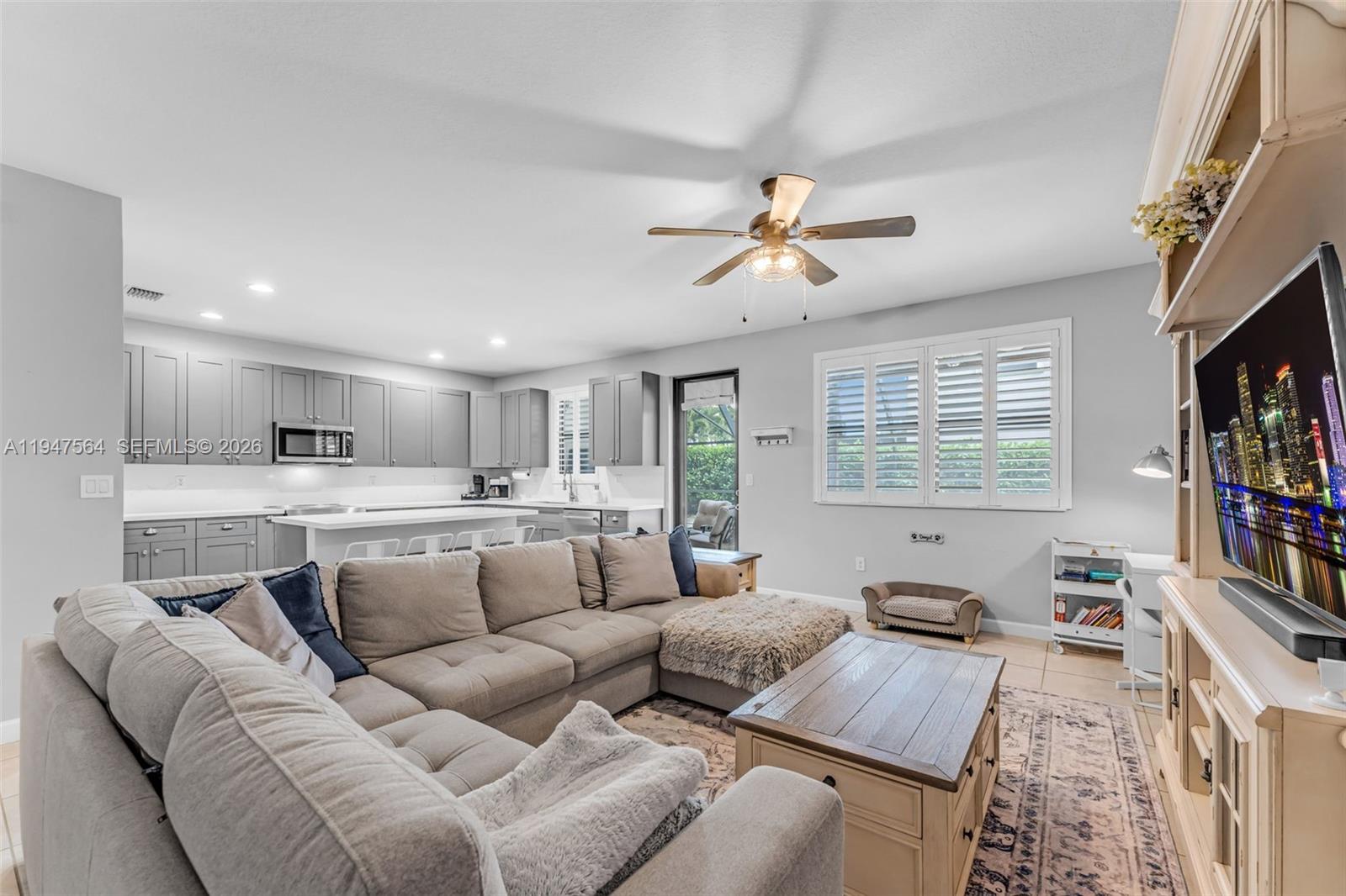 17475 Southwest 153rd Avenue Miami, FL 33187 - Photo 11 of 46 a living room with furniture and a flat screen tv