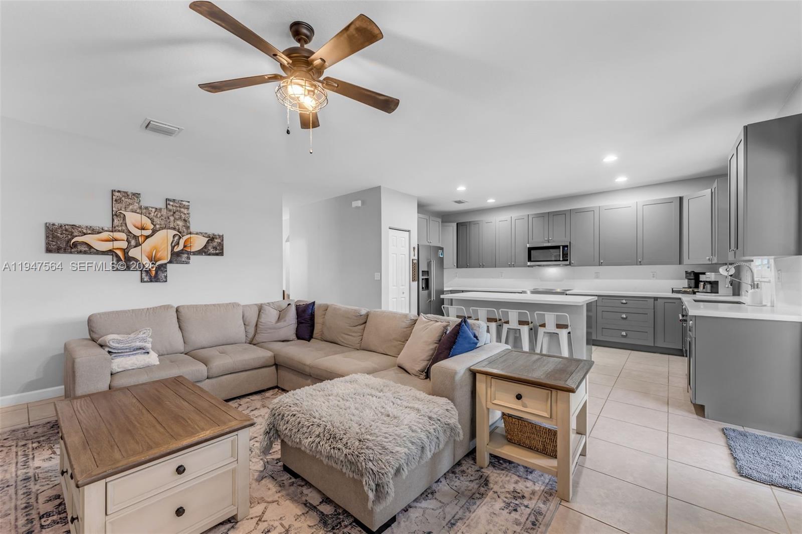 17475 Southwest 153rd Avenue Miami, FL 33187 - Photo 12 of 46 a living room with furniture and kitchen view
