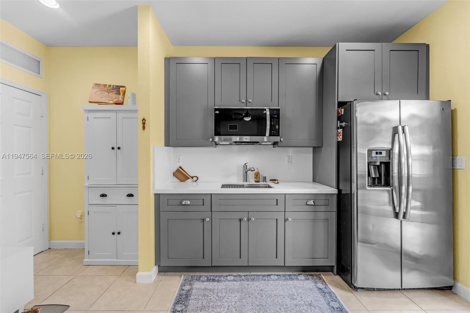 17475 Southwest 153rd Avenue Miami, FL 33187 - Photo 15 of 46 a kitchen with a refrigerator sink and cabinets