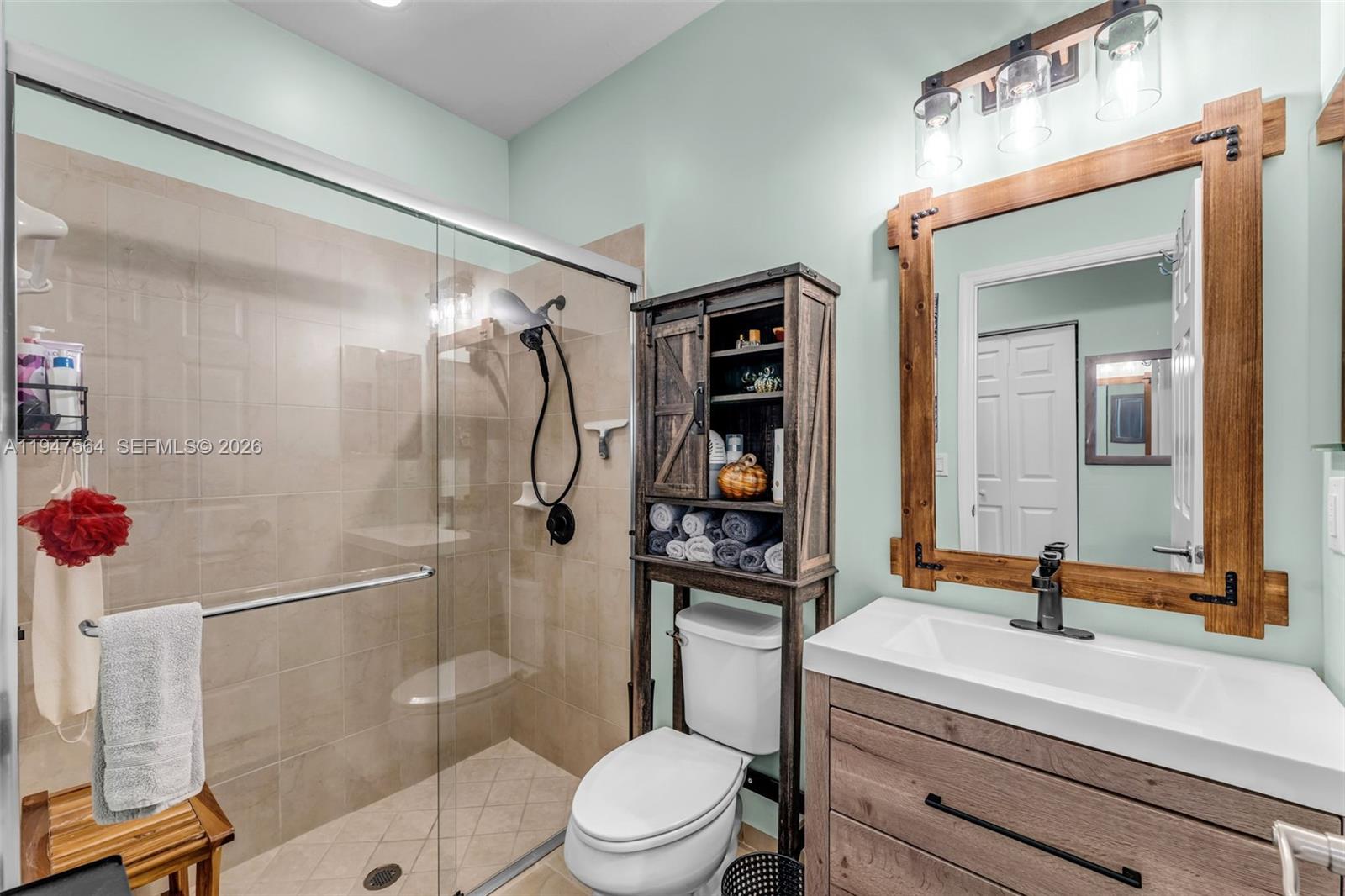 17475 Southwest 153rd Avenue Miami, FL 33187 - Photo 19 of 46 a bathroom with a sink a toilet and shower