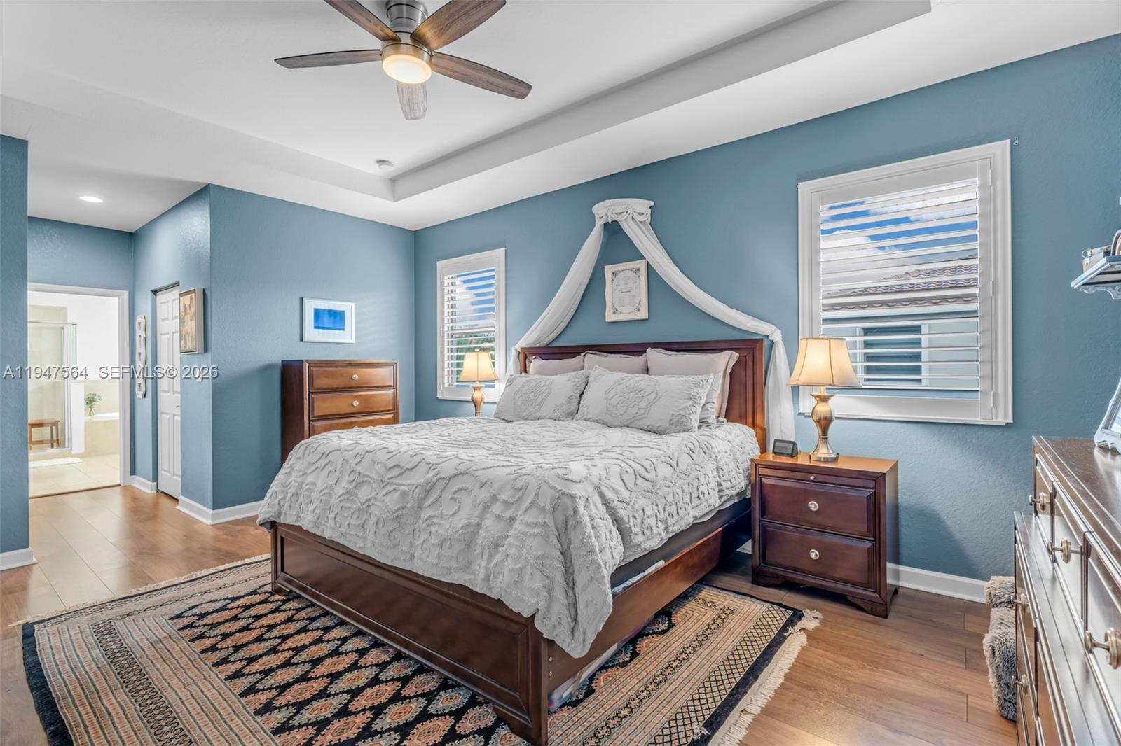 17475 Southwest 153rd Avenue Miami, FL 33187 - Photo 22 of 46 a bedroom with a bed and a chandelier