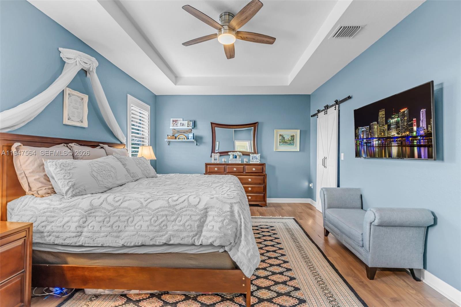 17475 Southwest 153rd Avenue Miami, FL 33187 - Photo 23 of 46 a bedroom with a large bed couch and a window