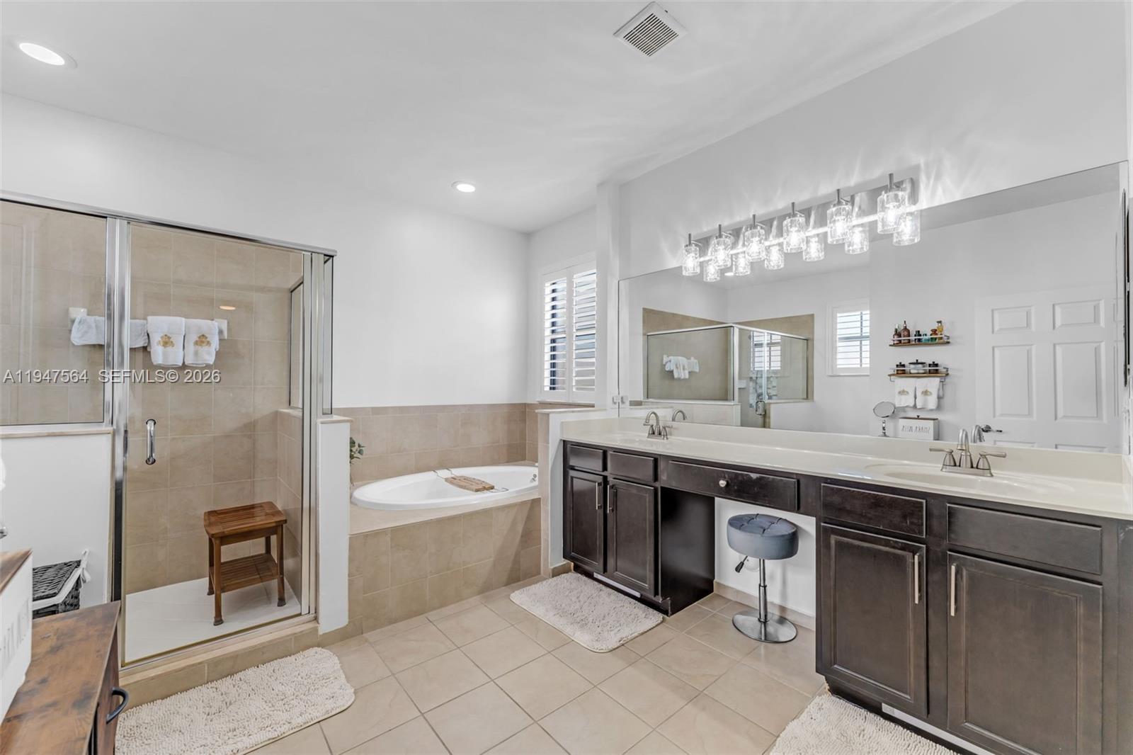 17475 Southwest 153rd Avenue Miami, FL 33187 - Photo 24 of 46 a spacious bathroom with a sink a toilet a mirror and bathtub