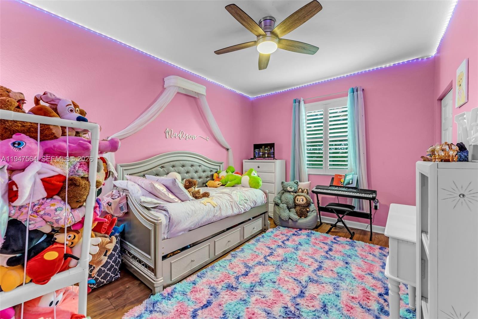 17475 Southwest 153rd Avenue Miami, FL 33187 - Photo 30 of 46 a bedroom with a bed and a chandelier