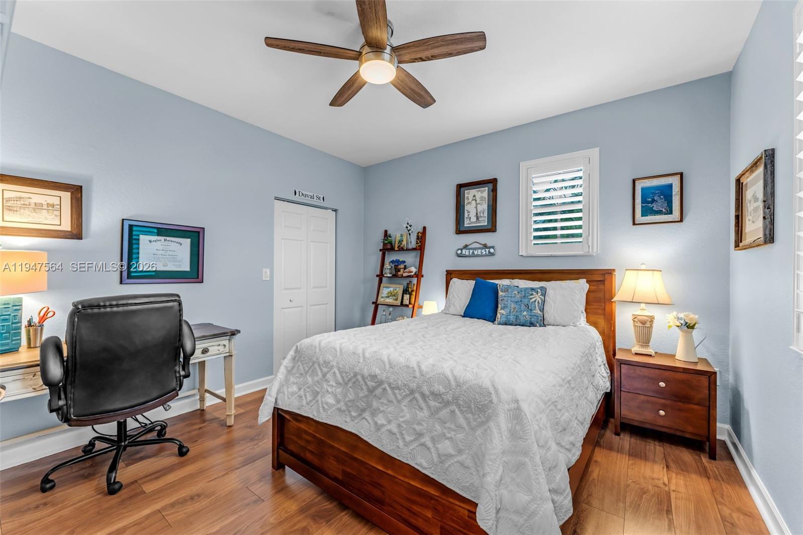 17475 Southwest 153rd Avenue Miami, FL 33187 - Photo 31 of 46 a bedroom with a bed and a chandelier