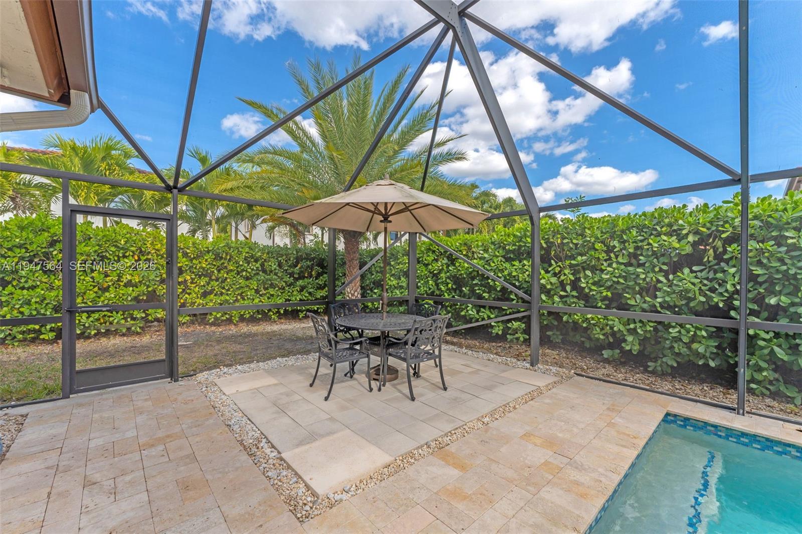 17475 Southwest 153rd Avenue Miami, FL 33187 - Photo 35 of 46 a patio with a patio table and chairs