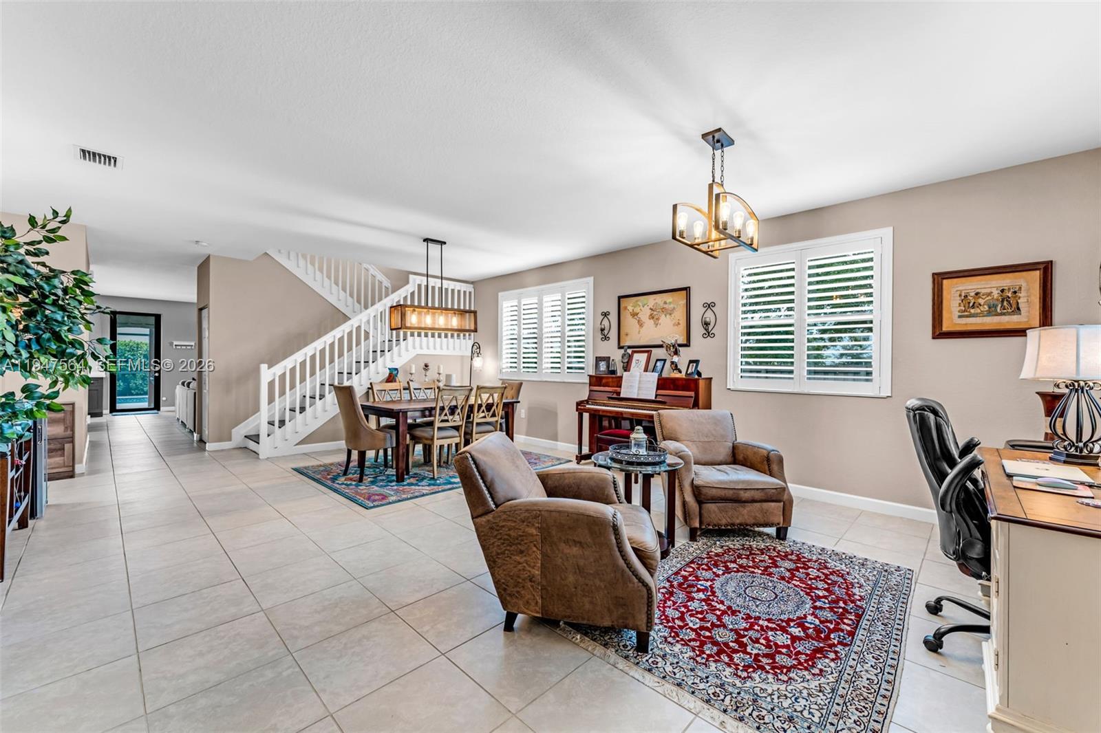 17475 Southwest 153rd Avenue Miami, FL 33187 - Photo 5 of 46 a living room with furniture a window and a chandelier
