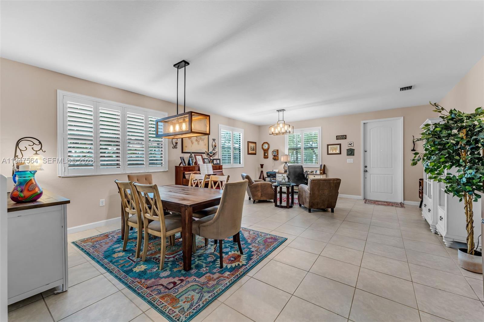 17475 Southwest 153rd Avenue Miami, FL 33187 - Photo 7 of 46 a living room with furniture a window and a potted plant