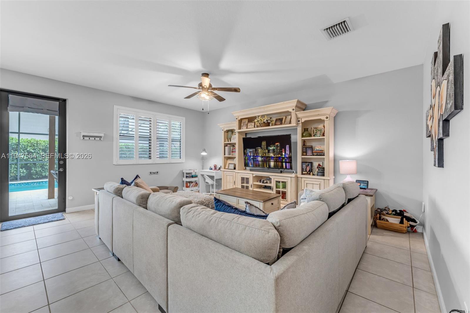 17475 Southwest 153rd Avenue Miami, FL 33187 - Photo 10 of 46 a living room with furniture and a large window
