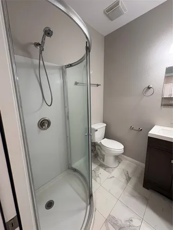 a bathroom with a glass shower door