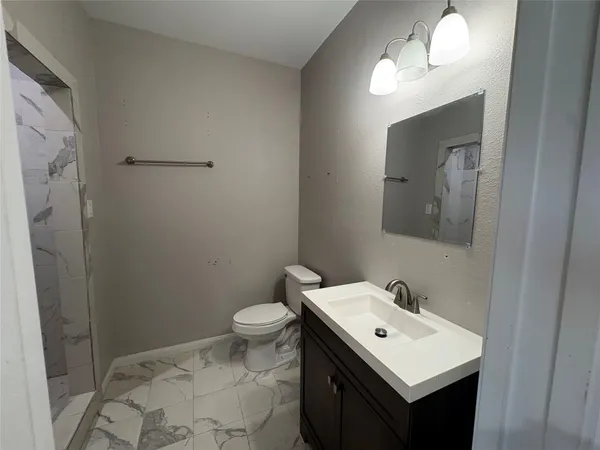 a bathroom with a sink toilet and mirror