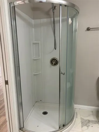 a bathroom with a glass shower door
