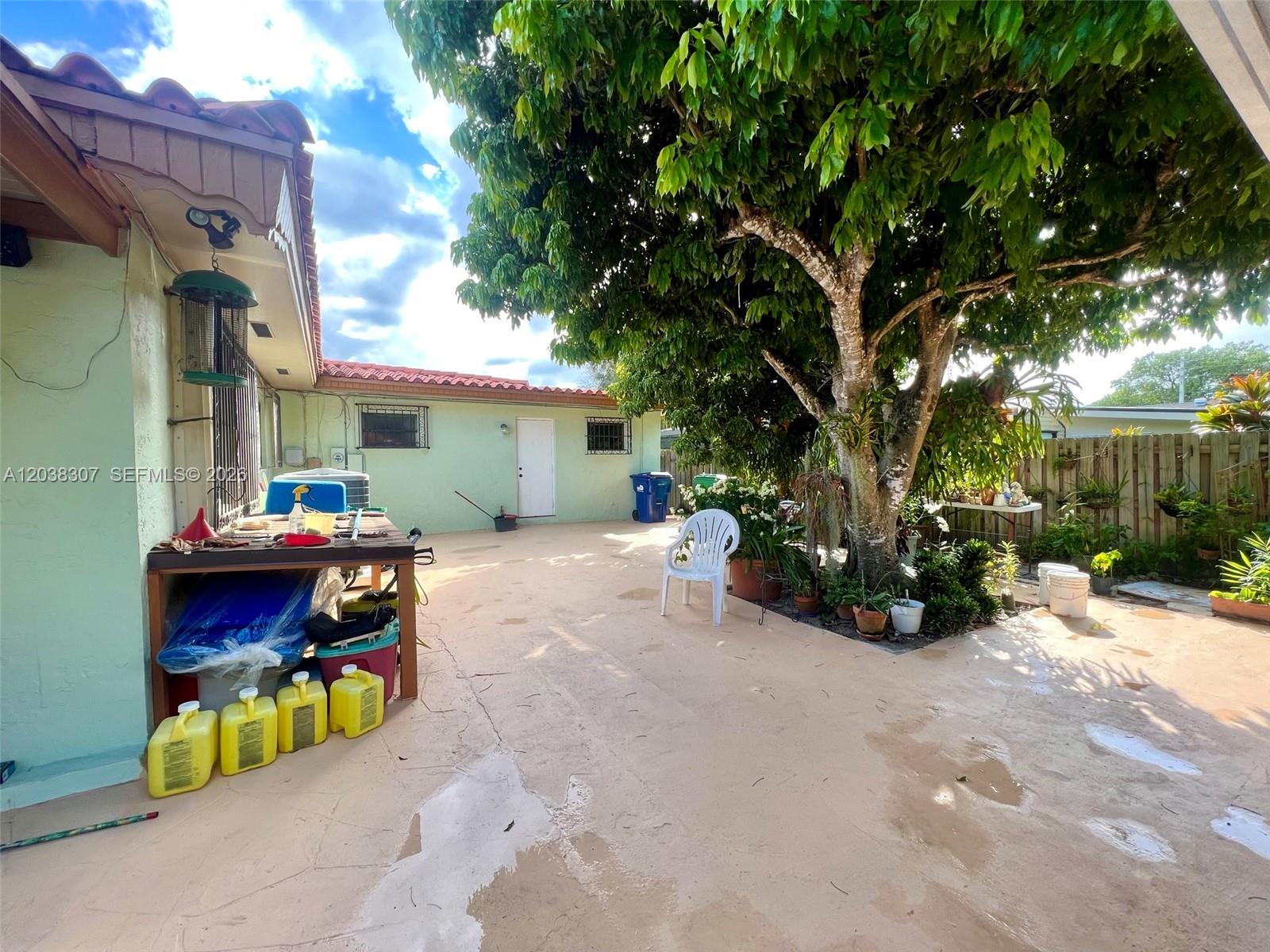 9601 Southwest 66th Street Miami, FL 33173 - Photo 42 of 62 a view of house with outdoor seating area and covered with trees