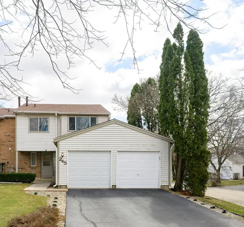 a view of house with a tree and a yard