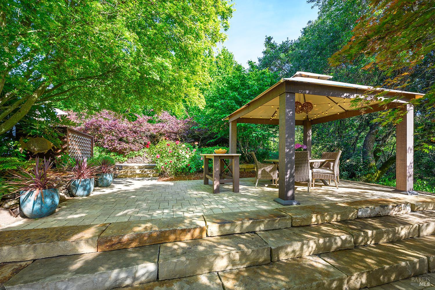3696 Newbury Court Santa Rosa, CA 95404 - Photo 41 of 52 a view of a patio with a table and chairs under an umbrella