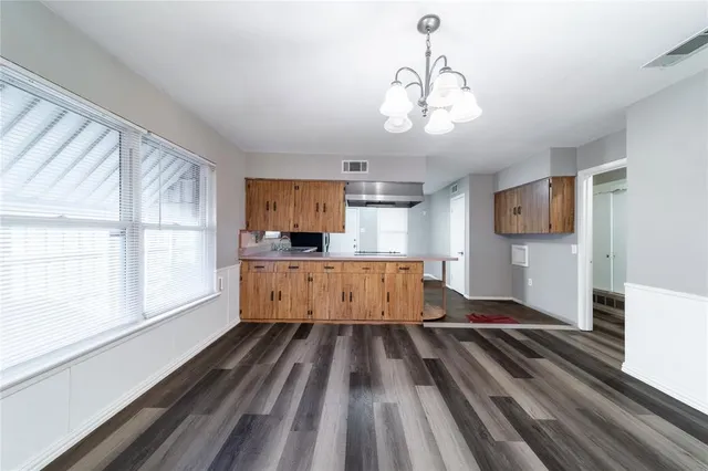 a view of kitchen with sink microwave and cabinets