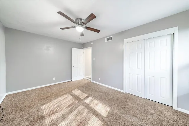 a view of a livingroom with a ceiling fan and window