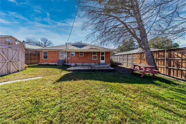 front view of a house with a yard table and chairs