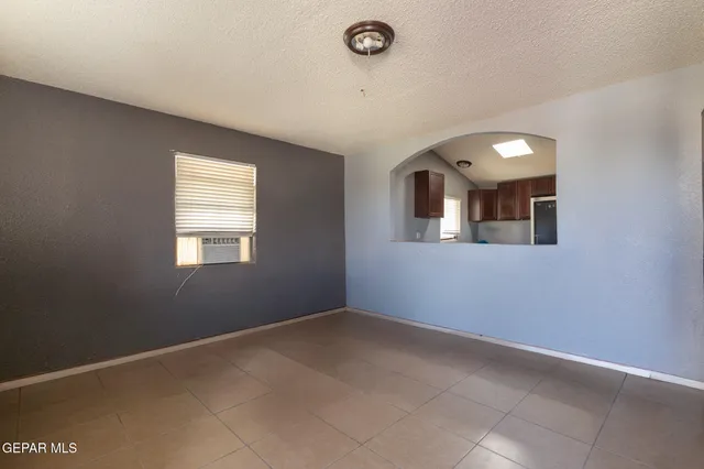 an empty room with a empty space and windows