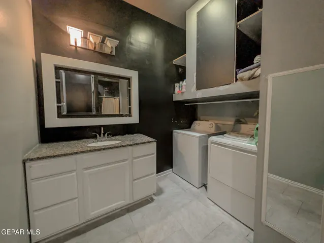 a bathroom with a toilet sink vanity and shower