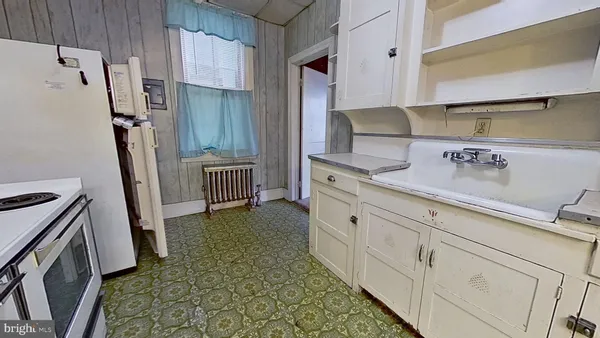 a kitchen with granite countertop a refrigerator and a stove